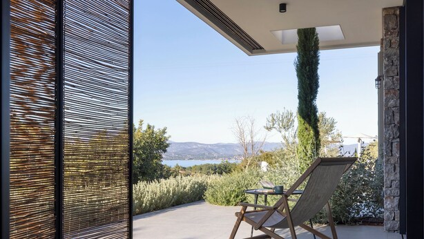 A modern outdoor seating area with a view of the landscape.