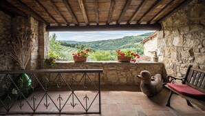A rustic stone-walled room with a wooden ceiling, a bench, and potted plants. - Typical farmhouse in the heart of Chianti with private swimming pool  (Toscana)