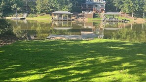A lakeside property with a dock, a gazebo, and a large house with a deck. - Waverly Creek Retreat-kayaks/fire pit/pet friendly (Jackson's Gap)