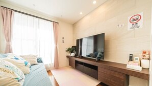 A hotel room with a bed, a TV, a desk, and a sign prohibiting smoking. - Upscale Sumida Retreat: Skytree Views, Workspaces & Premium Decor, 6 people (Sumida City)