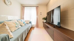 A modern bedroom with a bed, a TV, and a wooden cabinet. - Upscale Sumida Retreat: Skytree Views, Workspaces & Premium Decor, 6 people (Sumida City)