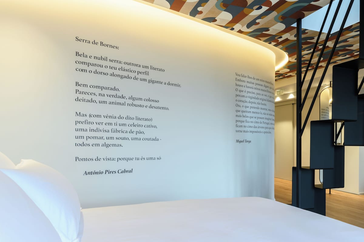 A modern interior with a curved ceiling and a wall displaying text.