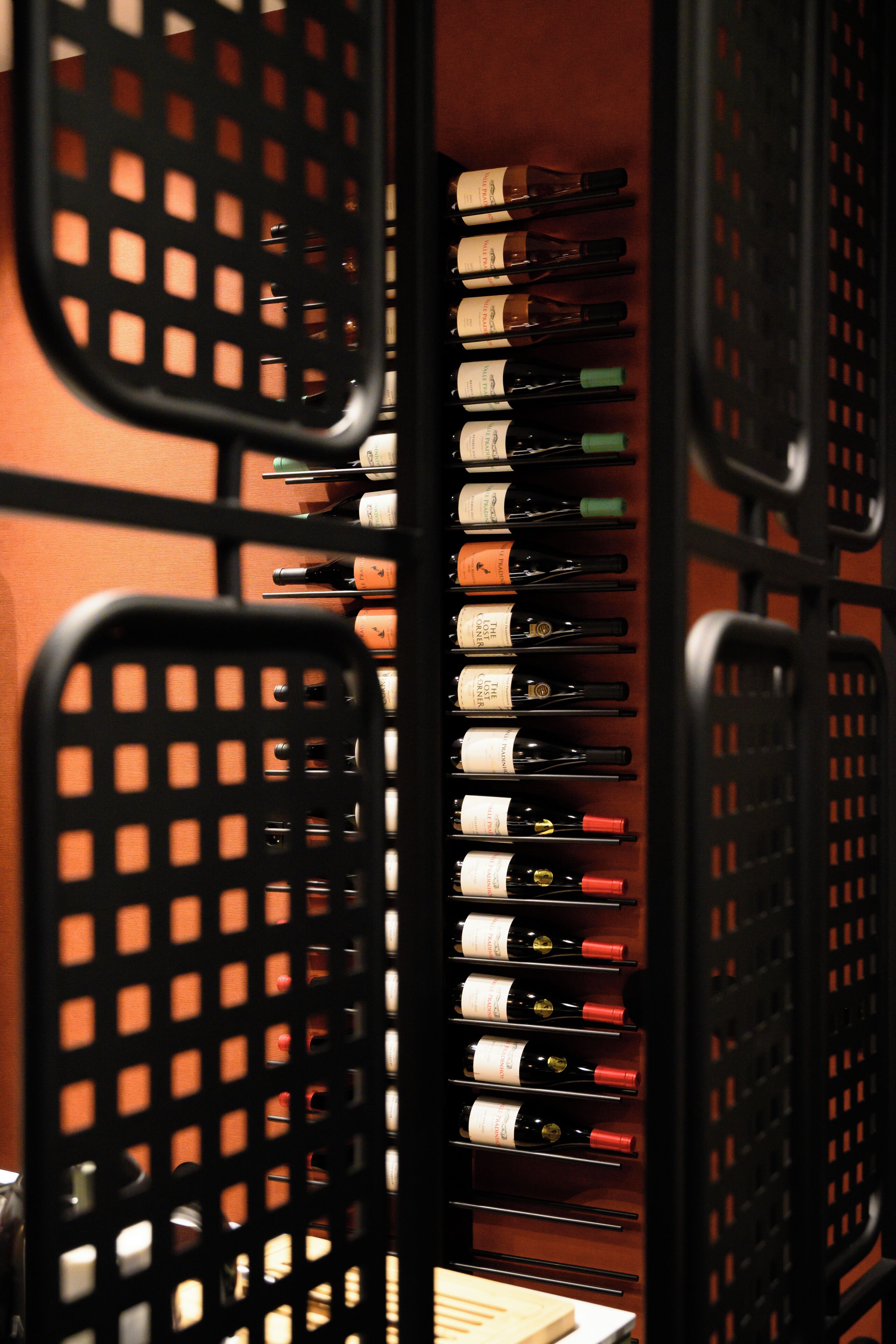 A wine rack with multiple bottles of wine.