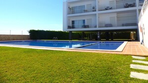 A modern multi-story building with a swimming pool in front. - Fuseta Formosa Village (Olhao)