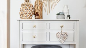 A white dresser with a mirror, starfish decor, and a heart-shaped mirror.