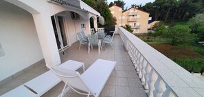 Enjoy a peaceful meal or relax on the balcony overlooking the garden and surrounding buildings.