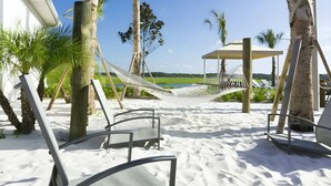 A beach area with hammocks, lounge chairs, and a gazebo. - Last Minute Disney Getaway! Private Pool & Themed Bedrooms. Book Now! #127919 (Orlando)