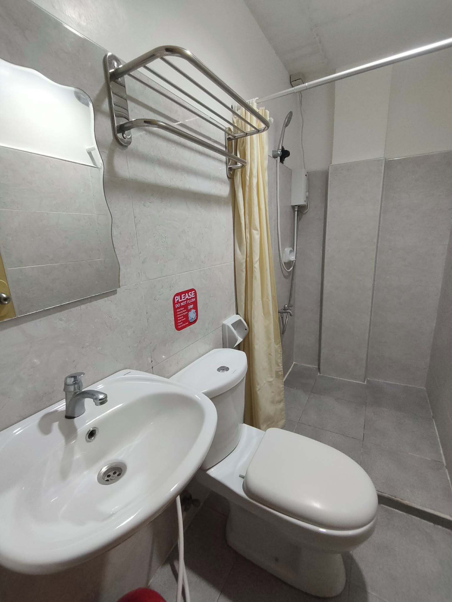 A bathroom with a sink, toilet, and shower.