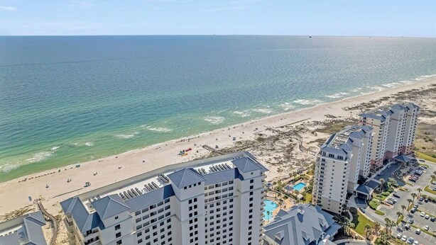 A beachfront hotel with multiple high-rise buildings, a sandy beach, and a clear view of the ocean. - 4 BR Top Floor Beachfront Condo | Beach Club B2010 (Baldwin County)