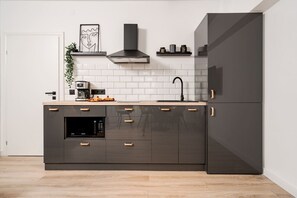 Enjoy cooking in this well-equipped kitchen with an oven, microwave, and stainless steel range hood.
