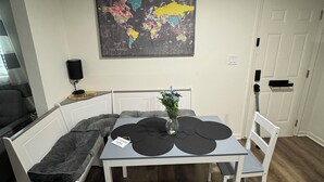 A dining area with a table, benches, and a world map on the wall. - Cozy and relaxing apartment with Free WiFi located in vibrant Atlanta. (Atlanta)