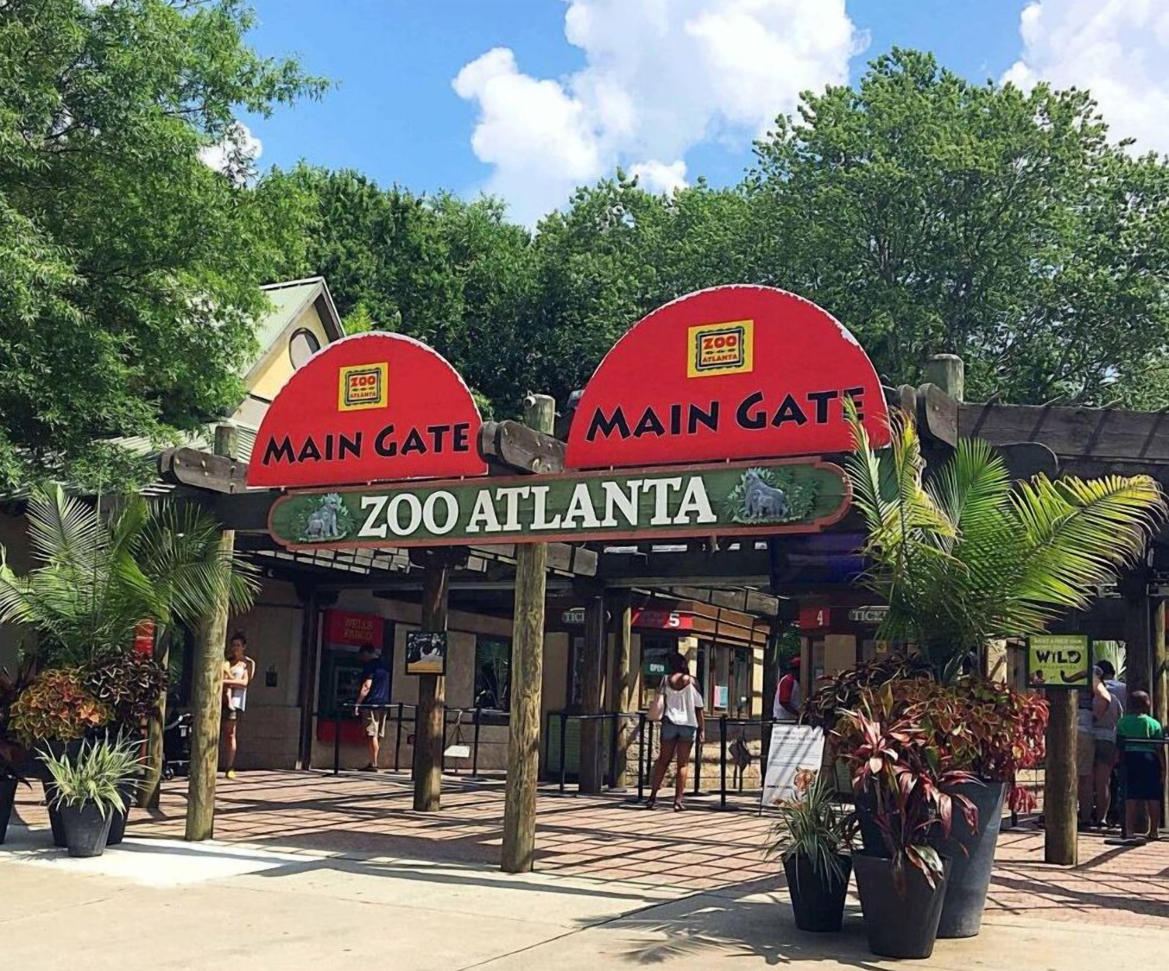 The entrance to Zoo Atlanta with two prominent red arches labeled "Main Gate" and "Main Gate" with the zoo's name beneath.