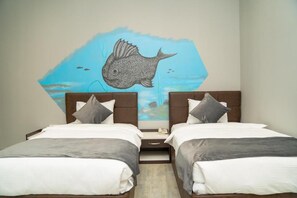 A room with two beds, a wall mural of a fish, and a nightstand between the beds. - Port Marine Hotel (Baku)