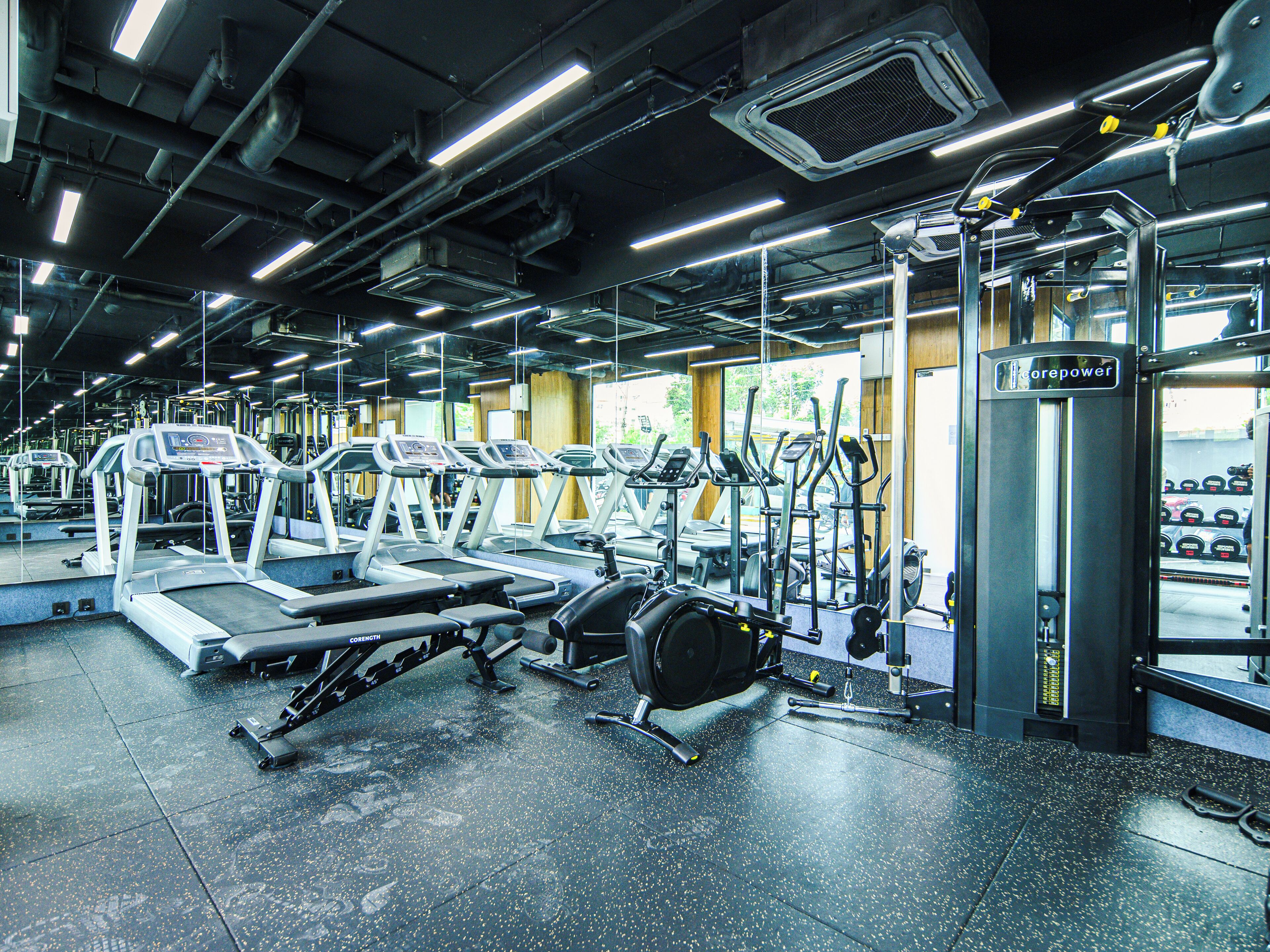 A gym with treadmills, elliptical machines, and weight equipment.
