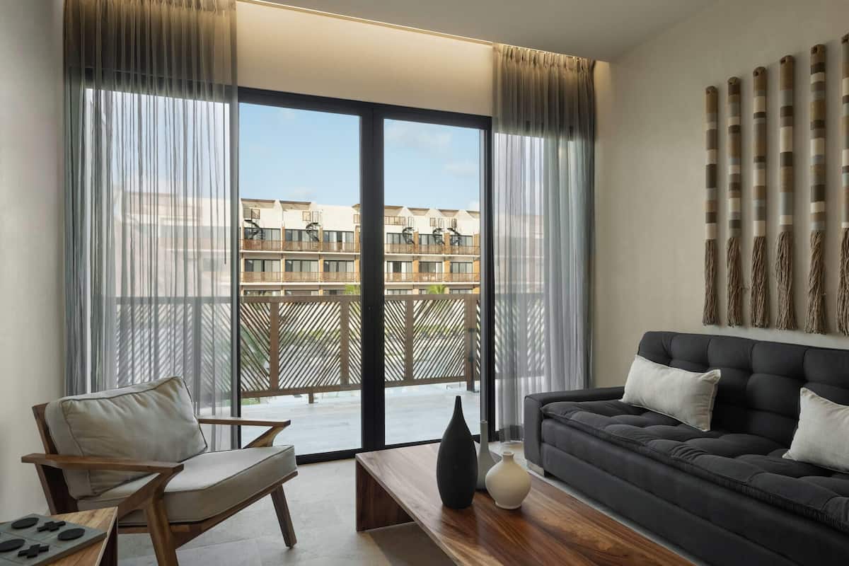 A modern living room with a sofa, a chair, and a coffee table.