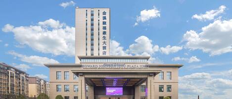 A modern hotel with a prominent entrance and a large digital display.
