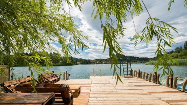 A wooden dock extending into a calm lake, surrounded by lush greenery and a clear sky. - Apartments Galić - 1 Bedroom with Lake view (Ploce)