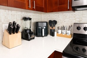 A kitchen with a blender, coffee maker, knife block, and utensils. - Miami 2BR Home • Jackson Hospital - Parking (Miami)