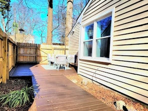 Enjoy dining or socializing on the patio surrounded by a lush garden.