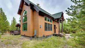 A wooden cabin with a large window, a deck, and a covered porch. - Mtn Escape w/ Hot Tub, By Trails in Grand Lake! (Grand Lake)