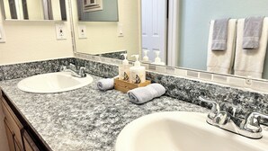 A bathroom with two sinks, a mirror, and a towel rack. - Charming 1-bedroom, 20 mins to Airport, Beaches, Gaslamp (Spring Valley)
