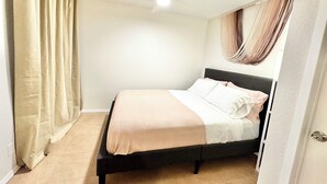 A bedroom with a bed, beige curtains, a ceiling fan, and a window with curtains. - Charming 1-bedroom, 20 mins to Airport, Beaches, Gaslamp (Spring Valley)