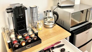 A kitchenette with a coffee maker, toaster, kettle, and various kitchen utensils. - Charming 1-bedroom, 20 mins to Airport, Beaches, Gaslamp (Spring Valley)