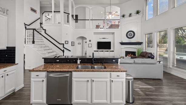 A spacious kitchen with a central island, white cabinetry, and a stainless steel dishwasher. - Keller’s Crown - Huge House Near Stadiums - Hot Tub & Pool Table (Keller)