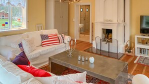 Una sala de estar con un sofá blanco, una mesa de centro y una chimenea.