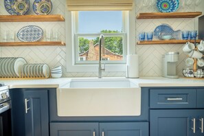Fridge, oven, coffee/tea maker, cookware/dishes/utensils