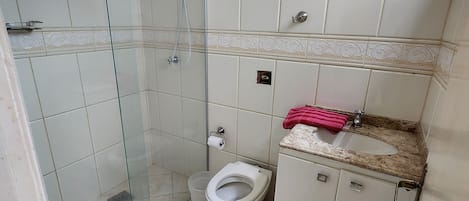 Chuveiro, toalhas de banho, papel higiênico