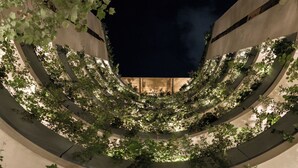 A circular architectural structure with a central void, surrounded by greenery. - ONTO Alvaro Obregon Mexico City (Mexico City)