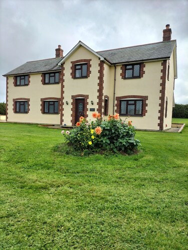 Spacious farmhouse set in countryside with far reaching views on a working farm.