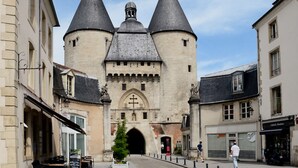 A historic building with a central tower, arched entrance, and surrounding buildings. - Sunset Lovers - WiFi - Netflix - Cosy atmosphere (Nancy)
