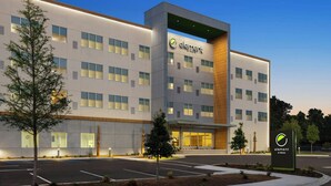 A modern hotel building with a prominent 'element by Westin' sign, featuring a clean, contemporary design with multiple windows and a well-lit entrance. - Element by Marriott Charleston Airport (North Charleston)
