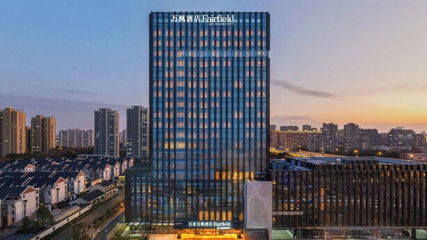 A high-rise hotel with a modern glass facade, multiple floors, and a prominent signage at the top. - Fairfield by Marriott Hangzhou Gongshu (Hangzhou)