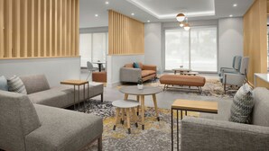 A modern living room with sofas, a coffee table, and a dining area. - TownePlace Suites by Marriott® Jacksonville Mayport (Atlantic Beach)