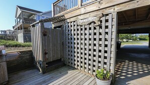 A wooden deck with a wooden fence, a potted plant, and a sign that reads "Love the Beach." - Pelican's Way - 4 BR Oceanfront Cottage in Southern Shores (Southern Shores)