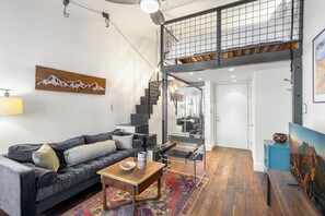 A modern living room with a sofa, coffee table, and artwork.