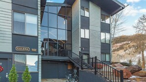 A modern two-story building with a visible garage, a staircase leading to the upper floor, and a sign reading "GALENA".