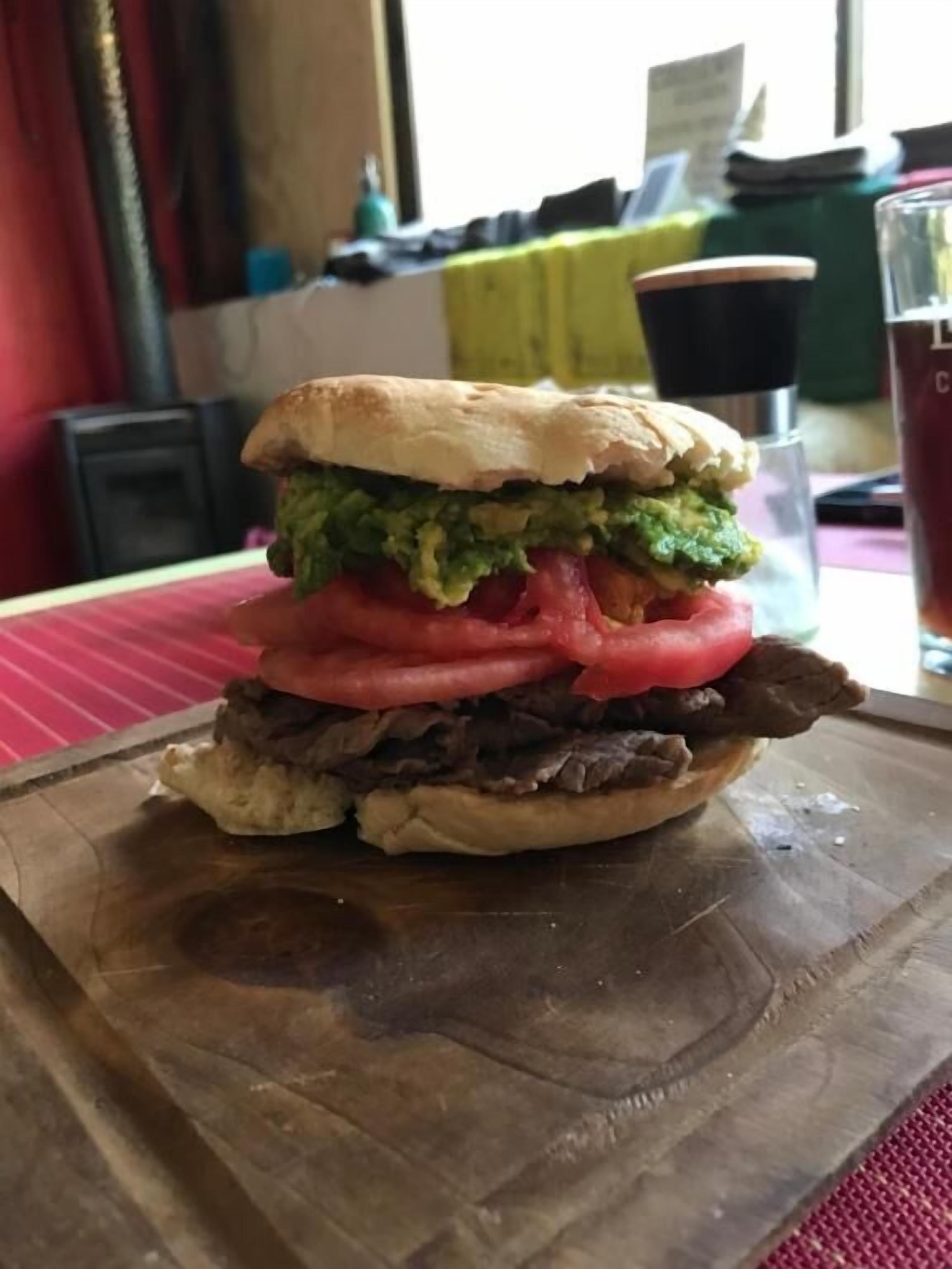 A sandwich on a wooden board.