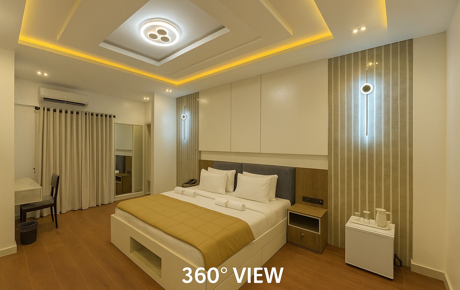 A modern hotel room with a large bed, bedside tables, a desk, and a wardrobe.