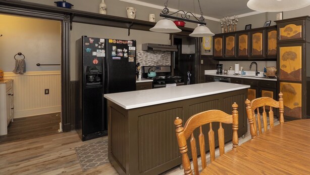 A kitchen with a central island, wooden chairs, a dining table, and a built-in oven. - The 2,400 sq. ft. Plymouth Paddock near Road America, 4 bedrooms, 2.5 bathrooms  (Plymouth)