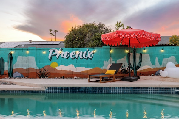 Poolside paradise with mural backdrop & glowing sunset