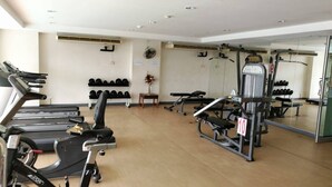 A gym with treadmills, weight machines, and dumbbells. - Cosy room like home, The Central Bangkok Station (Krung Thep Maha Nakhon)