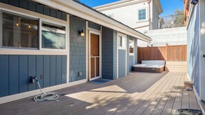A wooden deck with a hot tub and a sliding glass door. - Capitola Village Home - Free Parking & Sleeps 8! (Capitola)