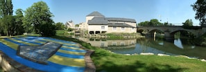 A historic building with a large courtyard, a bridge, and a moat.