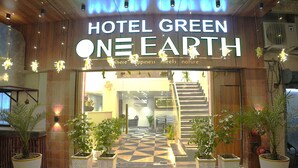 The entrance of Hotel Green One Earth with a checkered floor and potted plants. - Hotel Green One Earth (Amritsar)