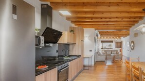 A modern kitchen with a built-in oven, a microwave, and a sink.