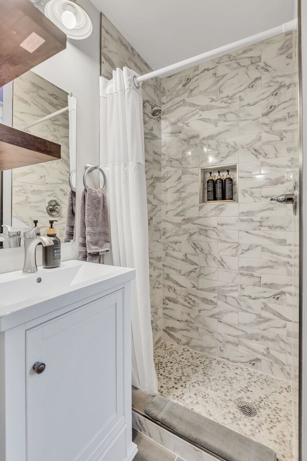 Shower, hair dryer, towels, shampoo